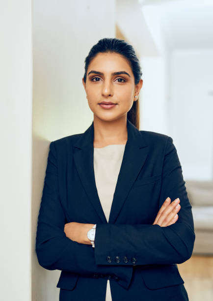 portrait of a young woman standing in an office